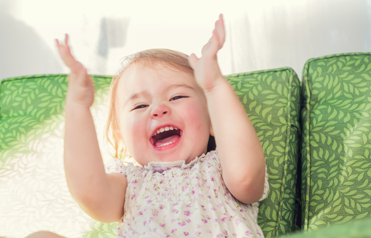 Toddler girl smiling and clapping her hands